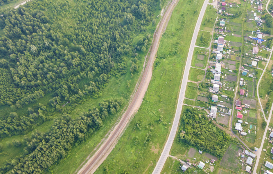 An aerial view of Big Cove, Alabama, showcasing lush green landscapes, winding roads, and charming residential homes. The serene setting highlights the natural beauty and peaceful environment of the region.