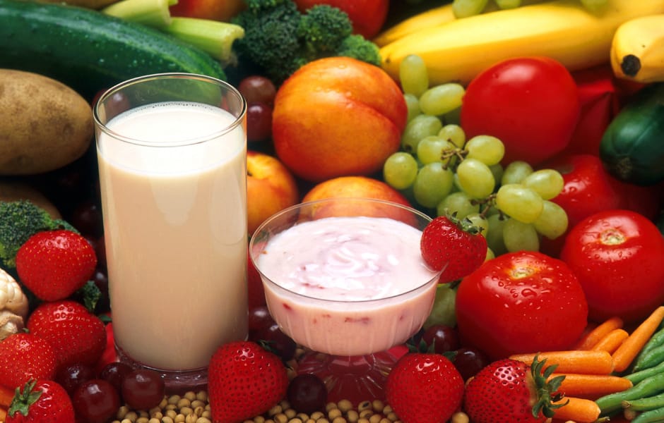  A colorful assortment of fruits and vegetables alongside a glass of milk and a bowl of yogurt, emphasizing the wholesome power of fruits and veggies breakfast routine.