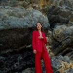 woman in red suit posing for a photoshoot