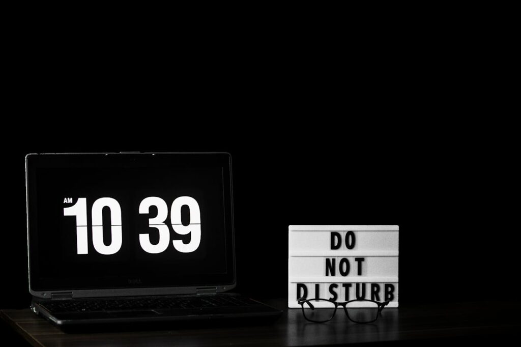 Close-up image of a clock showing time, with the dark background. Representing Quick Tips on Balancing Breaks and Focused Work Time.