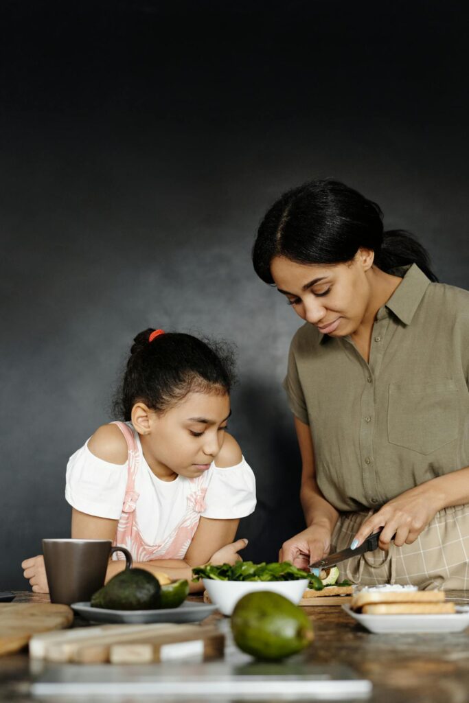 Image of a mother and daughter bonding over cooking together in a warm and intimate kitchen setting. Image used for the article Can a Stay-at-Home Mom Collect Social Security Disability?