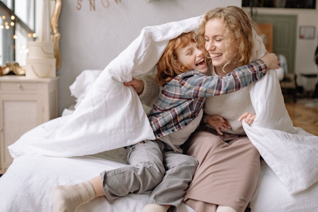 Mother laughing with her daughter after spending quality time with her.