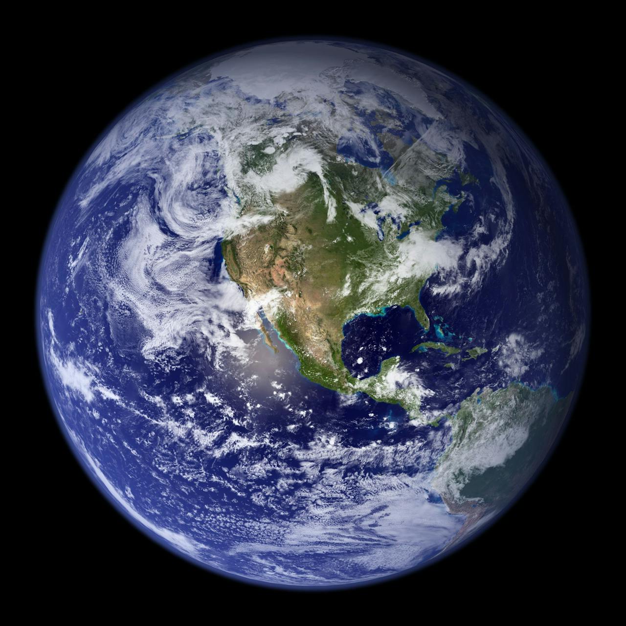 Image of a high-resolution view of Earth from space, showing North America, swirling clouds, and blue oceans.