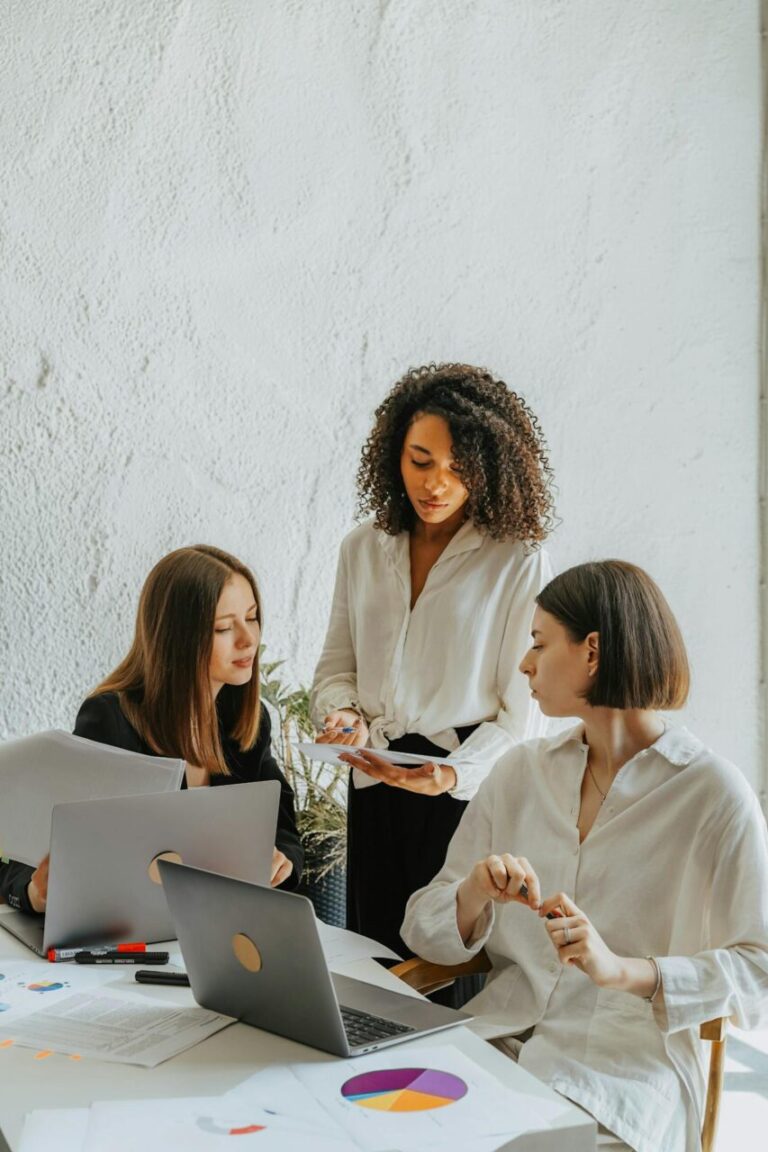 image of three women working on a project in the office.